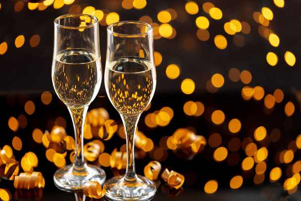 Two glasses of Champagne against bokeh lights background - Φωτογραφία, εικόνα