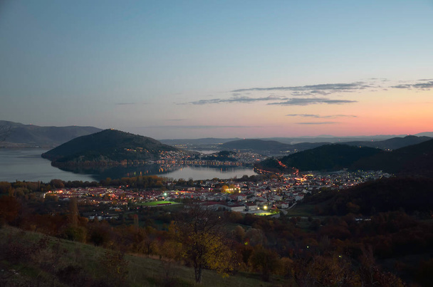 Scenery view from  the hill in the evening of Kastoria, town and suburbs and lake Orestiada - Photo, Image