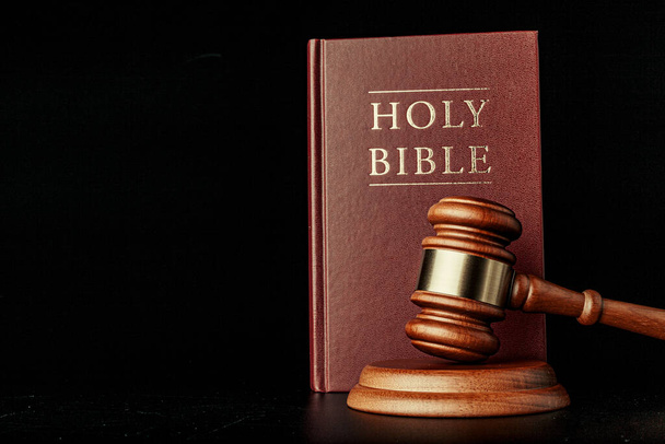 judge gavel with holy bible on black background - Foto, afbeelding