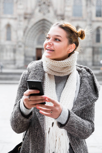 girl using mobile phone in scarf - Foto, Bild