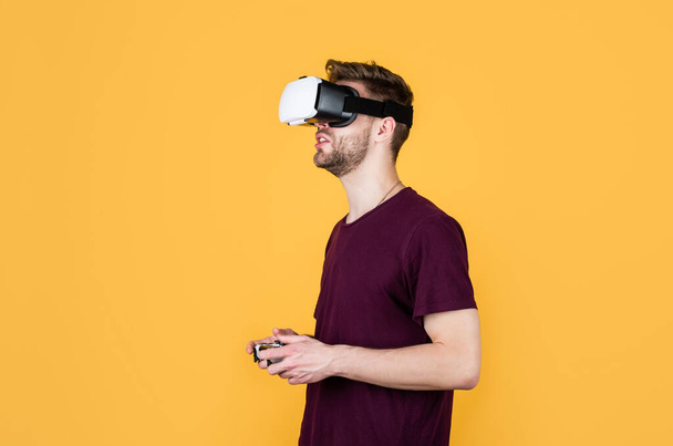 Another reality is here. male in VR headset. gamer use modern technology. Digital future and innovation. Visual reality. man in wireless VR glasses. guy play video games. game player with console - Fotografie, Obrázek