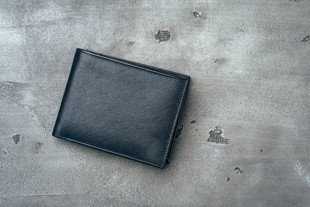 Black leather wallet on grey concrete background - Foto, immagini