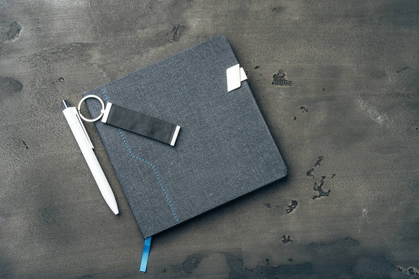 Male accessories notepad and pen on dark grunge surface - Fotografie, Obrázek