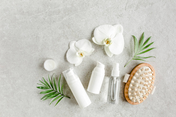 Essential oil, vegetable extract, serum, tropic palm leaves on gray marble background. Spa skincare concept. Natural Organic spa cosmetics products.  - Photo, Image