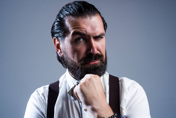 so serious. confident and elegant man in classical wear. masculinity and charisma. formal party dress code. old fashioned bearded hipster. trendy man in suspenders and bow tie - Valokuva, kuva