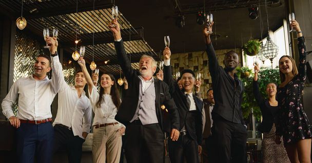 corporate businesspeople having business party toasting glasses of wine or champagne together to celebrate friendship and teamwork in special event such as corporate aniversary - Foto, Imagem