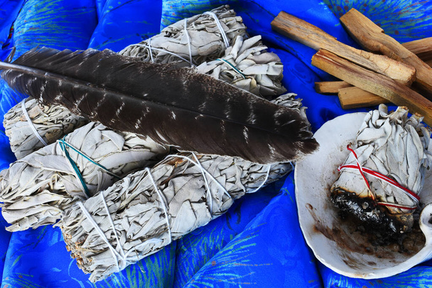 A top view image of ceremonial sage smudge sticks and sacred feather.  - Photo, Image