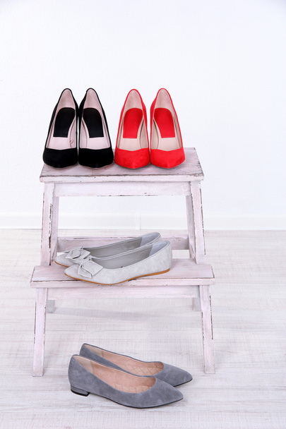 Beautiful female shoes on wooden shelf - 写真・画像