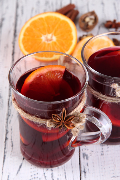 Mulled wine with oranges and spices on wooden background - Fotografie, Obrázek