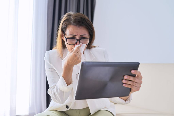 Sick business woman sneezing into handkerchief makes video call to doctor - Fotoğraf, Görsel