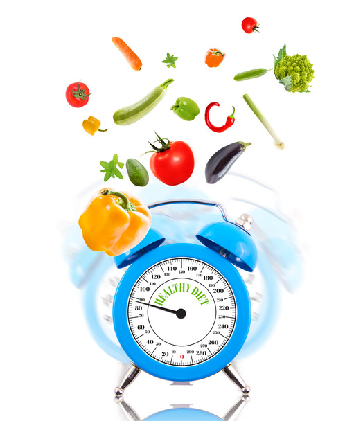 Концепція дієти з годинником, масштабним циферблатом та овочами
. - Фото, зображення