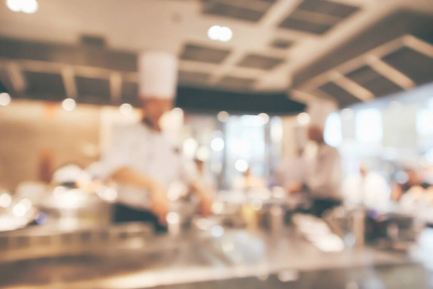 Chef cooking in restaurant kitchen blurred defocused background - Foto, Imagem
