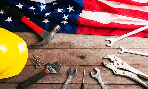 USA Labor day concept, Top view flat lay of different kinds wrenches with American flag on wood table. First Monday in September, creation of labor movement and dedicated to social of American worker - Fotografie, Obrázek