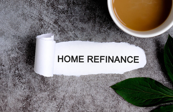 Home refinance with cup of coffee and green leaf - Fotó, kép