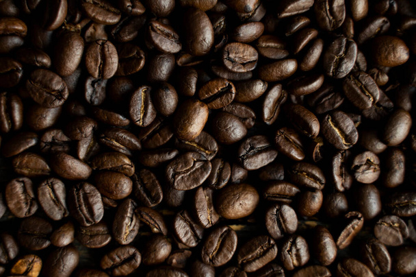 Fresh arabica coffee beans as a texture or background. - Foto, Bild