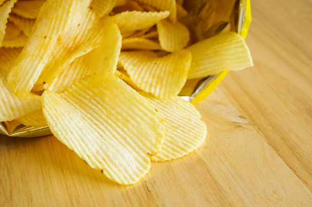 potato chips open bag on wood table - Photo, Image
