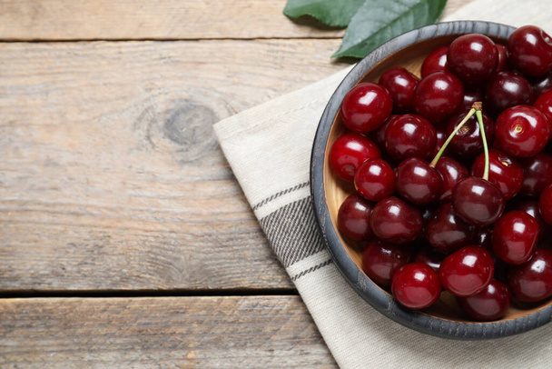 Sweet juicy cherries on wooden table, flat lay. Space for text - Photo, image