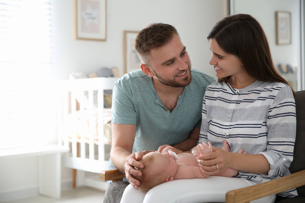 Happy couple with their newborn baby at home - Fotó, kép
