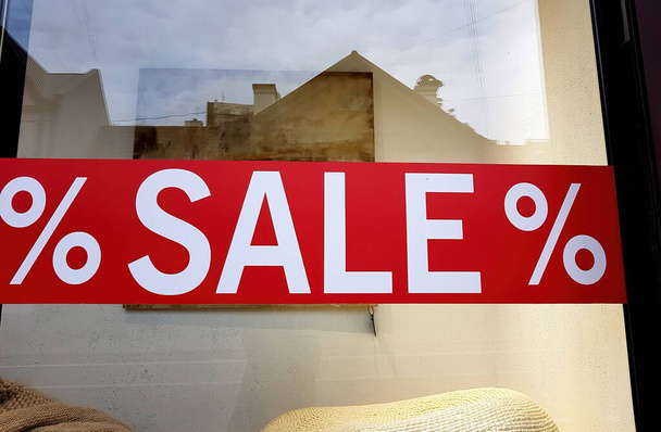 Sale sign on glass window shop.Shop window with sale sign on glass -% sale% - Photo, Image