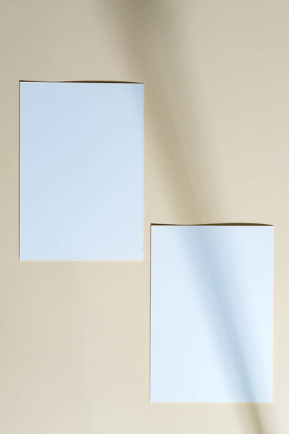 Two mock-up white template paper postcards for text or messages on a beige background with shadows, copy space. Top view. Greeting card. - Foto, immagini
