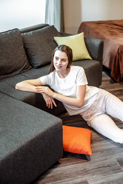 Young woman pretty relaxing on couch in living room. Casual style indoor shoot - Foto, Imagem