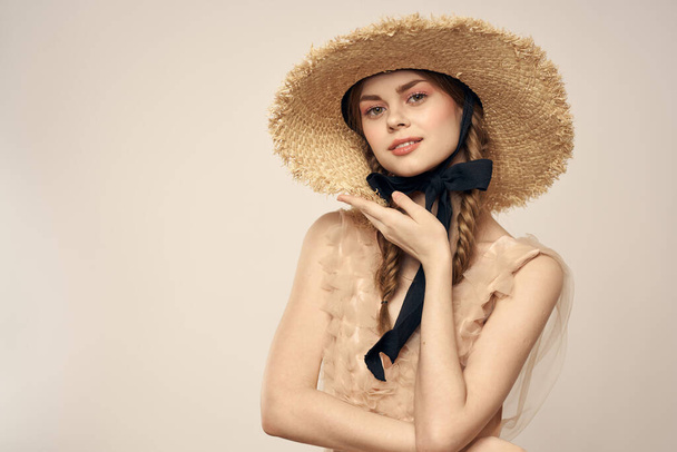 romantic girl in beige dress and in straw hat with black ribbon emotions portrait of model cropped view - Photo, Image