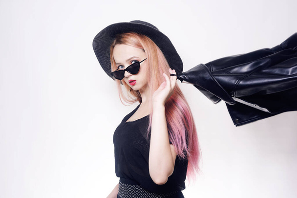 Girl with pink hair in glasses and a hat in black clothes in a leather jacket. Black Friday. - Photo, Image