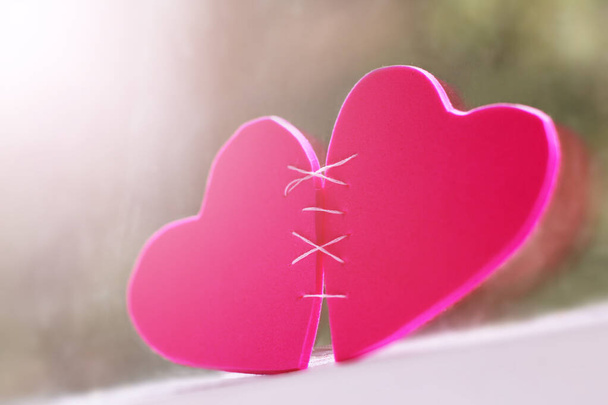 Two pink hearts on the window, love and happiness, sunlight toned - Photo, Image
