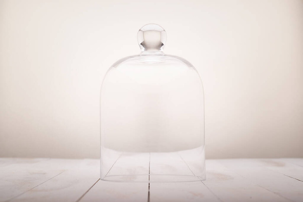 empty glass dome on a white wooden background - Foto, Imagen