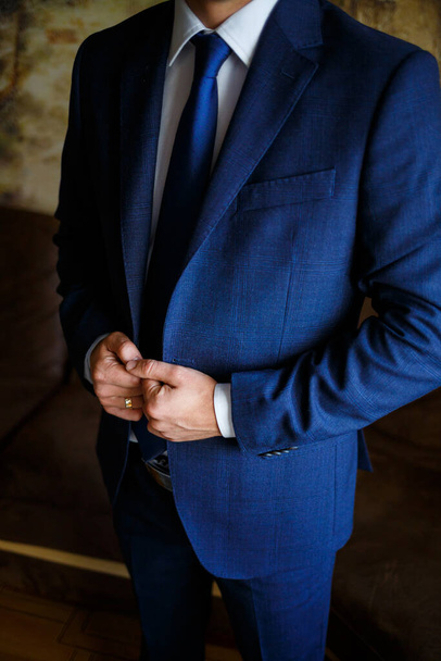 man puts on a suit on the wedding day - Photo, Image