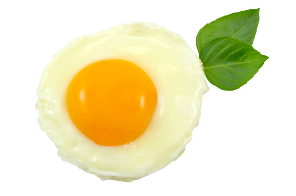 Fried egg with two basillico leaves isolated - Photo, Image