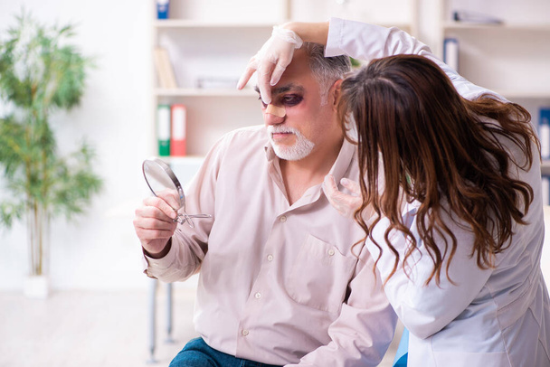 Old man visiting young female doctor for plastic surgery - Photo, Image
