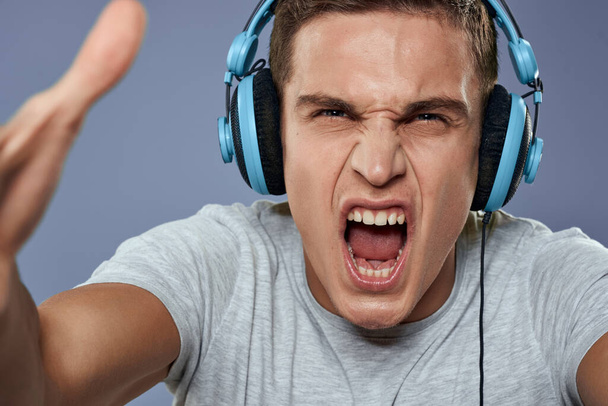 Man in headphones listens to music entertainment lifestyle white t-shirt blue background - 写真・画像