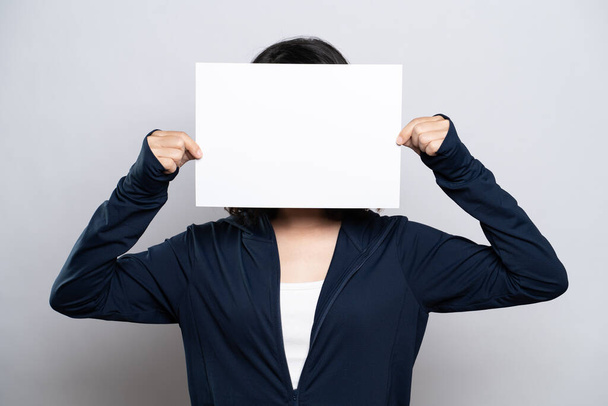 Πορτρέτο μιας υγιούς γυναίκας που δείχνει χαρτί καλύπτει το πρόσωπό της απομονωμένο σε λευκό φόντο - Φωτογραφία, εικόνα