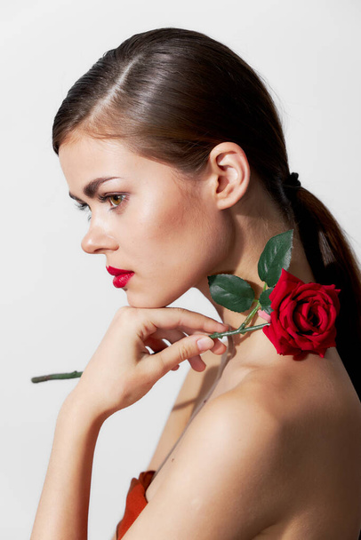 Woman with flower Red lips side view glamor bright makeup  - Fotó, kép
