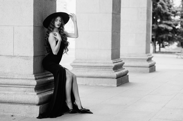 Ukrainian girl in a black dress outdoors in a hat - Photo, Image