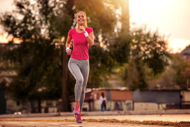 Running woman.Female fitness model training outside. - Foto, Imagen