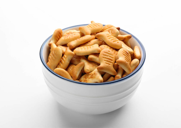 Delicious goldfish crackers in bowl isolated on white - Valokuva, kuva