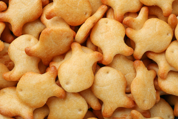 Delicious goldfish crackers as background, closeup view - Photo, image