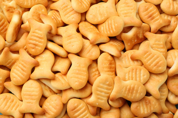 Delicious goldfish crackers as background, closeup view - Foto, Bild