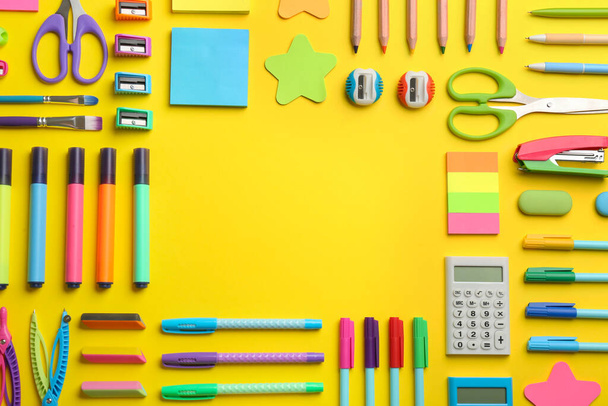 Frame of school stationery on yellow background, flat lay with space for text. Back to school - 写真・画像