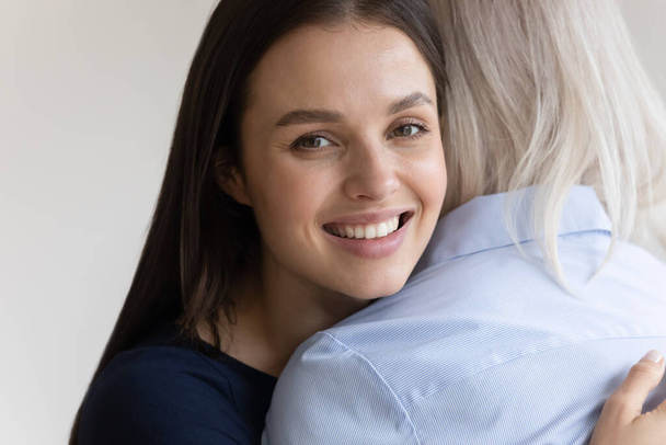Portrait of happy millennial girl hug senior mom - Photo, Image