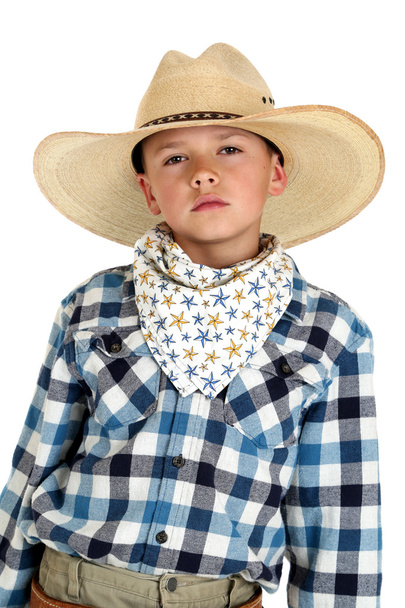 Young cowboy with a serious look wearing a large hat - Foto, Bild