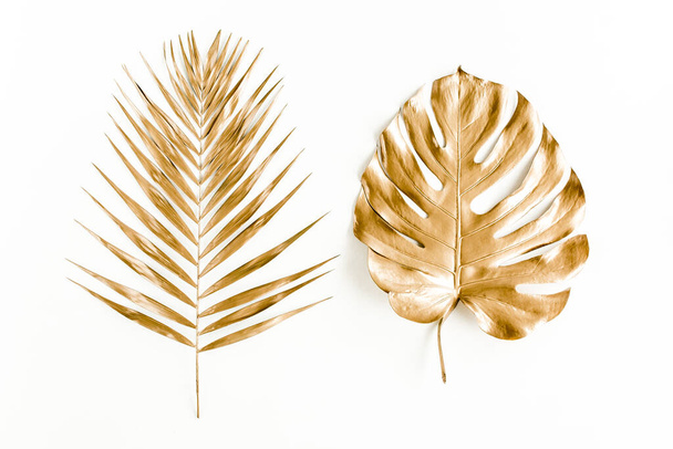 Gold tropical palm leaves Monstera on white background. Flat lay, top view minimal concept. - Fotografie, Obrázek
