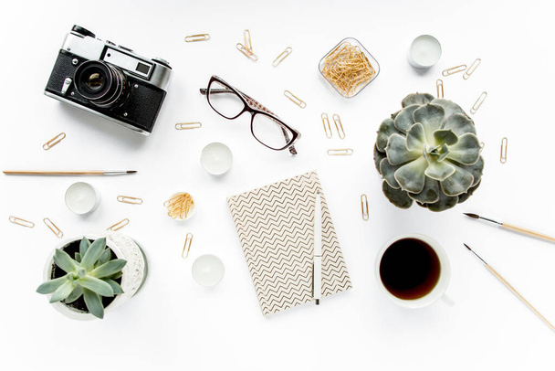 desk workspace with succulent, coffee, diary, glasses and golden clips on white background. flat lay, top view - Photo, Image