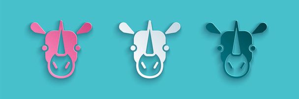 Иконка носорога вырезана бумагой на синем фоне. Символ животного. Бумажный стиль. Вектор. - Вектор,изображение