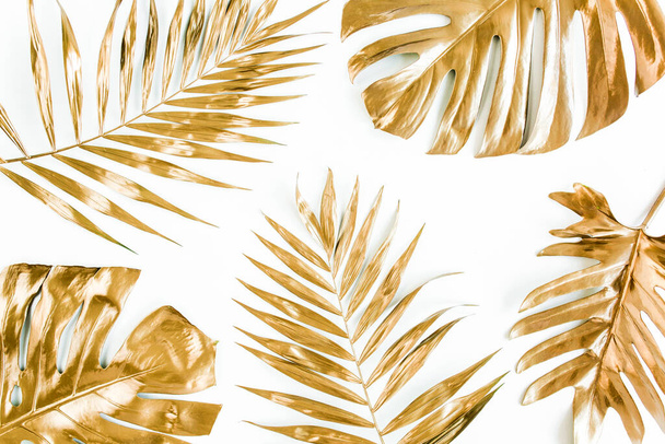 Gold tropical palm leaves Monstera on white background. Flat lay, top view minimal concept. - Foto, afbeelding