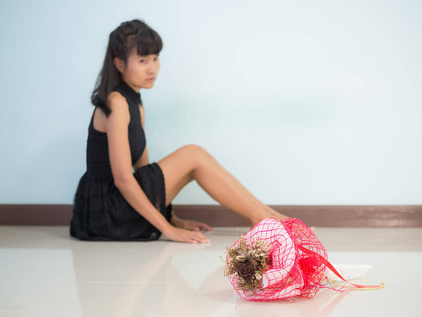 Broken heart woman concept.dry rose bouquet with sad woman sitting. - Valokuva, kuva