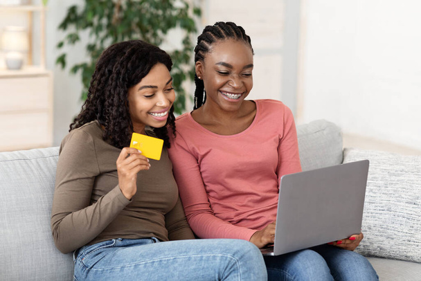 Cute african american besties shopping online together - Photo, Image