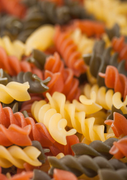 Raw homemade tricolore fusilli pasta as texture background. Macro - Valokuva, kuva